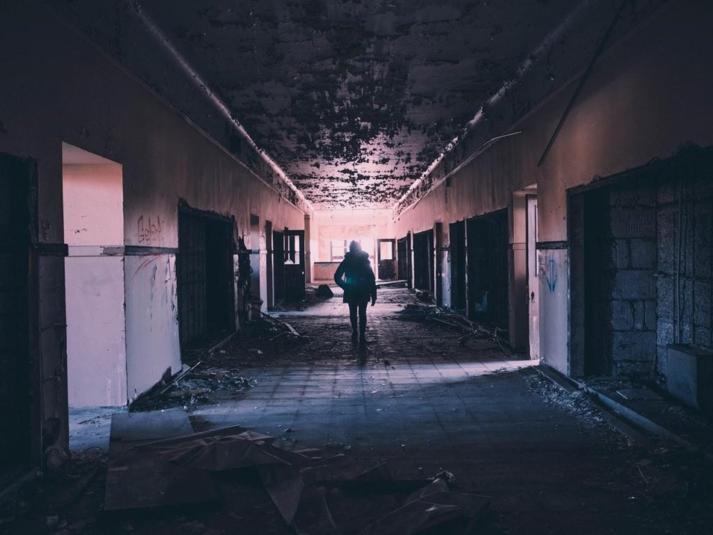A Human Silhouette Standing In A Hallway In An Abandon Building