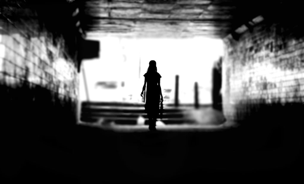 A Silhouette Of A Woman In A Tunnel