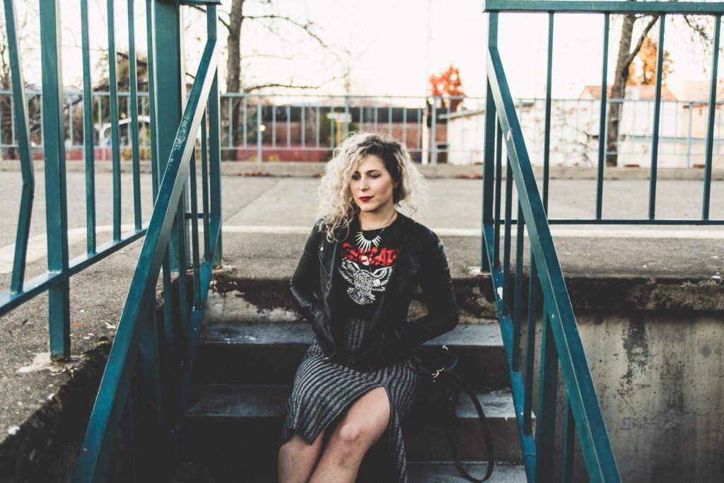 A Woman Wearing Black Leather Jacket And Skirt