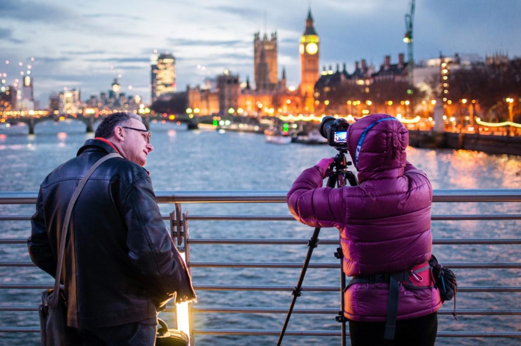 Man And Woman Taking A Photo Of London