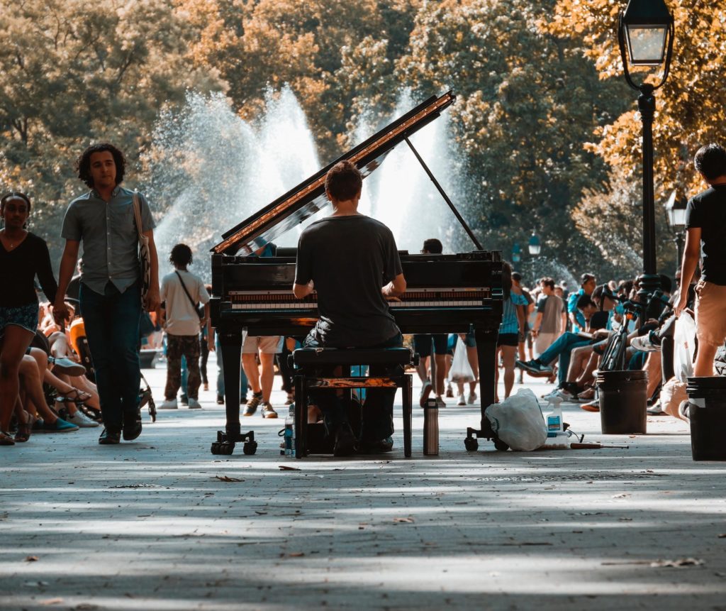 Man Playing Piano In The Middle Of The Park