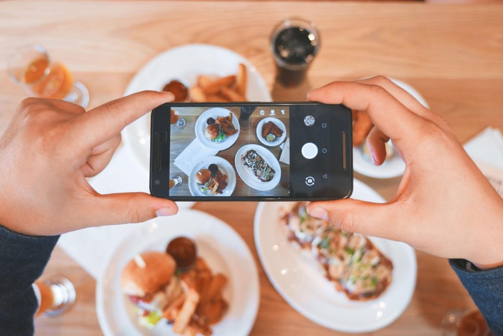 Person Taking Photos Of Food