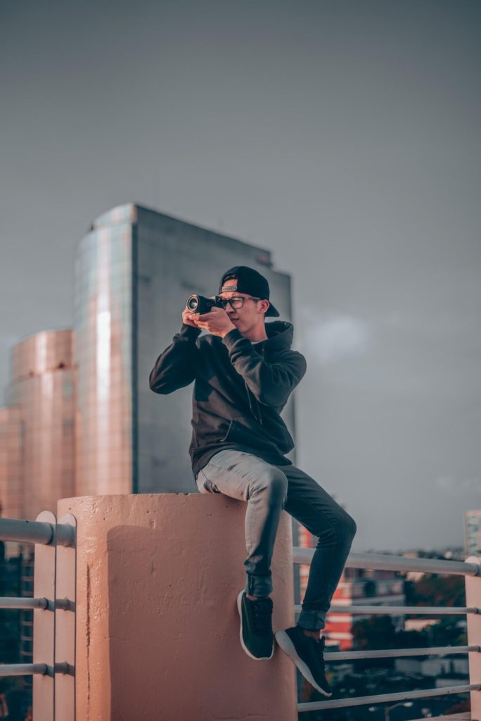 Man Taking A Photo On The Roof