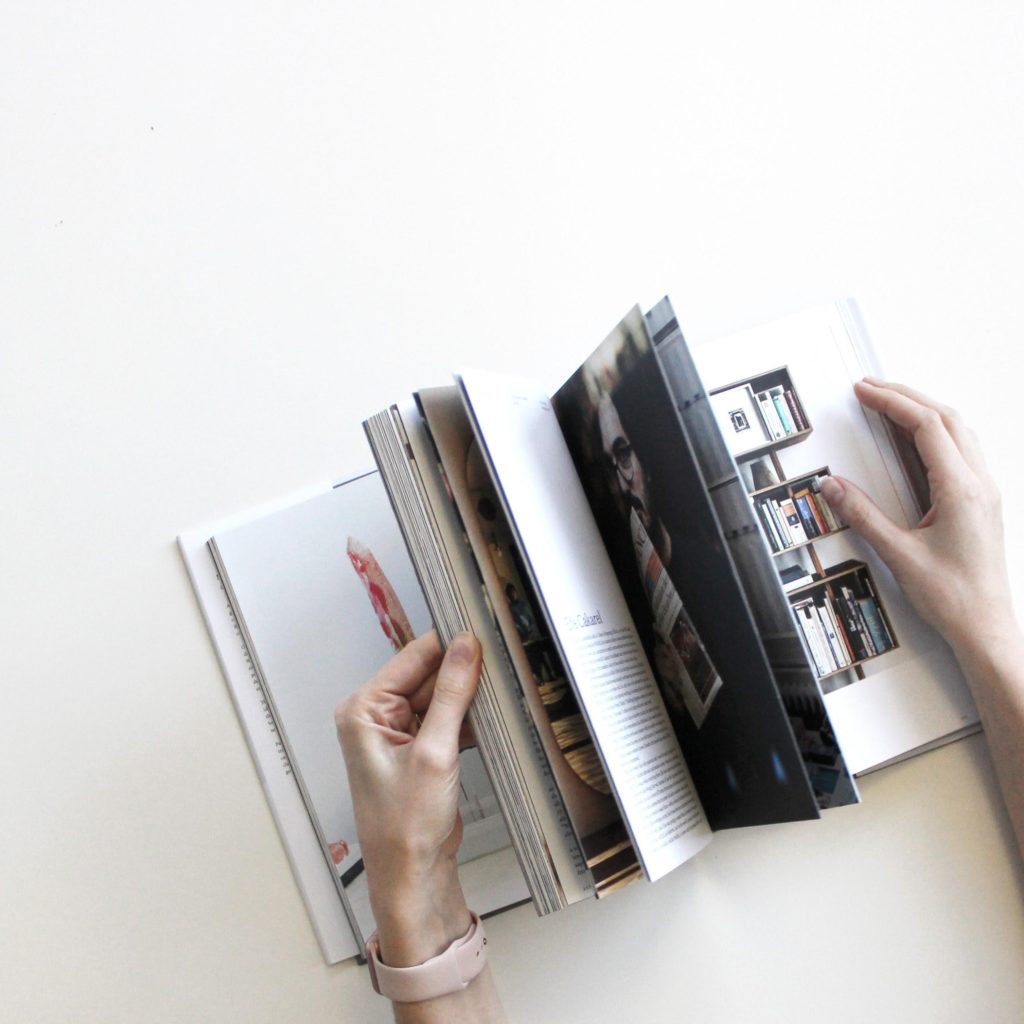 Photo Of A Person Flipping Through A Book