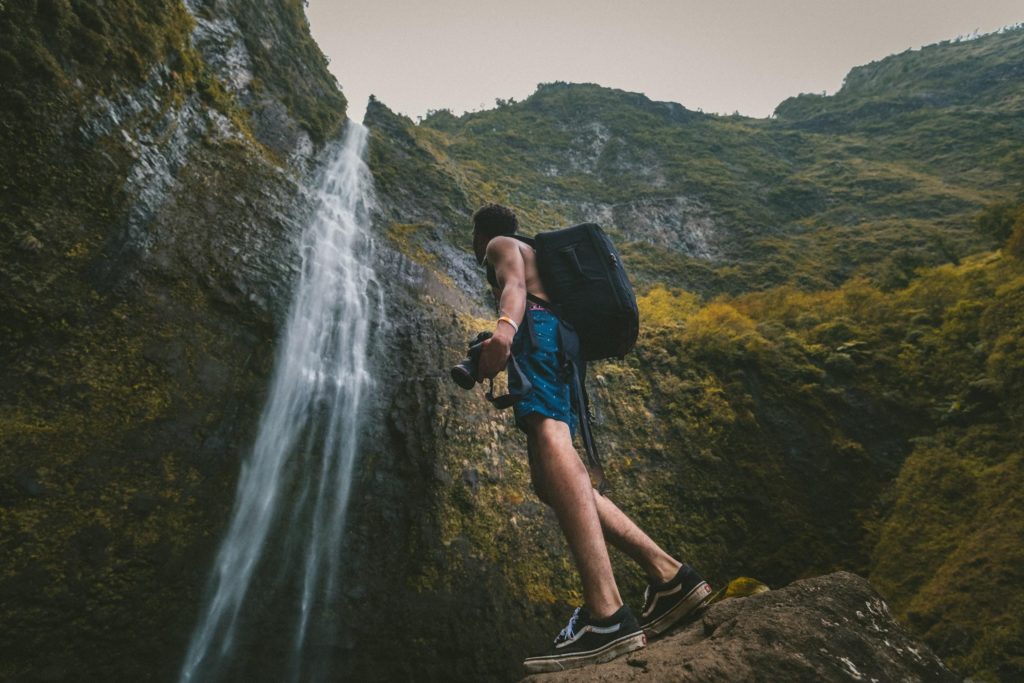 Shirtless Guy In Front Of A Waterfall