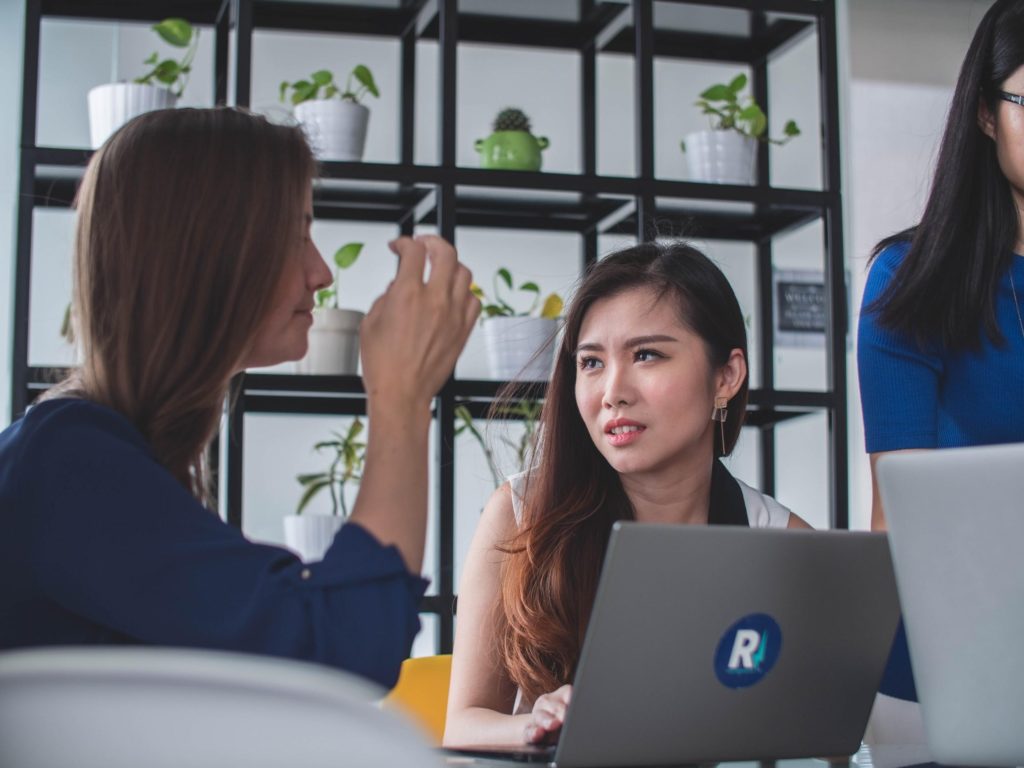 Two Woman In The Office Discussing