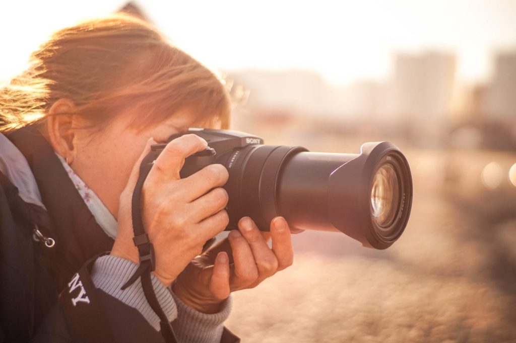 Woman Holding Up Sony Camera
